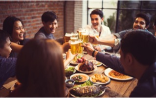 A group of coworkers are drinking and eating together